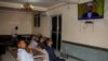 People watch news about the delayed election on a television in Mogadishu, Somalia, Jan. 28, 2021.