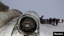 FILE - The wreckage of an airplane is seen after a crash in Deh Yak district of Ghazni province, Afghanistan, Jan. 27, 2020. 