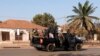 Armed soldiers move on the main artery of the capital after heavy gunfire around the presidential palace in Bissau, Guinea-Bissau, Feb. 1, 2022. 