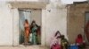Des femmes regardent passer des militaires à Kerawa, à la frontière du Nigeria où Boko Haram frappe, au Cameroun, le 16 mars 2016.