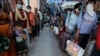 Warga India mengantri untuk melakukan tes Covid-19 di fasilitas yang didirikan di stasiun kereta api untuk menyaring orang-orang yang datang dari luar kota, Ahmedabad, India, Jumat, 18 September 2020. (Foto: AP)