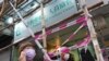 People walk past the entrance of the Hong Kong Professional Teachers' Union in Hong Kong, Aug. 10, 2021. 