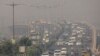 FILE - Traffic moves on a smoggy morning in New Delhi, India, October 23, 2020.