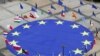 FILE - A large European Union flag lies at the center of Schuman Square outside European Commission headquarters in Brussels, Belgium, May 8, 2021. 