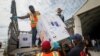 Boxes of AstraZeneca COVID-19 vaccine manufactured by the Serum Institute of India and provided through the global COVAX initiative arrive at the airport in Mogadishu, Somalia, March 15, 2021.