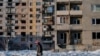 A child walks past a residential building, nicknamed the 'storybook' that was destroyed by shelling and is now occupied by Ukrainian forces in Avdiivka, Donetsk Oblast, Ukraine, Saturday 25 November 2017. Avdiivka, a city of about 20,000 people, sits righ
