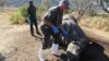 Kobus de Wed of the Crime Investigation Unit uses a metal detector to locate the bullet which may be matched to the gun used to hunt the rhino. (Photo: Gillian Parker for VOA)