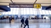 FILE - Sign points to a Transportation Security Administration checkpoint at Dulles International Airport in Dulles, Va., March 26, 2019.