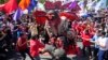 FILE - Activists destroy an effigy of Philippine President Rodrigo Duterte, center, with his daughter Davao city mayor, Sara, right, and Ferdinand 'Bongbong' Marcos Jr., son of the late dictator, during a protest in Quezon City, Philippines, Dec. 10, 2021.
