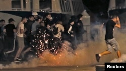 Police disperse revellers at the old port of Marseille after the England v. Russia - Group B match. 