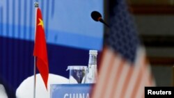 FILE - The Chinese and U.S. national flags are seen before the start of a Treaty on the Non-Proliferation of Nuclear Weapons conference with the U.N. Security Council's five permanent members, in Beijing, Jan. 30, 2019.