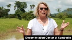 Youk Chhang, Elizabeth Becker and Michael ABRAMOWITZ, USHMM Director and his delegations at a B52 bomb pond near the Chinese airport, Kampong Chhnang province. Oct 24, 2012. Photo by Nhean Socheat. 