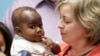 Foster mom Nancy Swabb holds Dominique, a 10-month-old baby born with two spines and an extra set of legs protruding from her neck during a news conference, March 21, 2017, at Advocate Children's Hospital in Park Ridge, Ill. 
