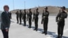Turkey's President Recep Tayyip Erdogan inspects a military honor guard before addressing supporters in Bursa, Turkey, Aug. 4, 2019. 