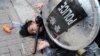FILE - Police arrest a protester after a Chinese flag was removed from a pole at a rally in support of Xinjiang Uighurs' human rights in Hong Kong, China, Dec. 22, 2019.