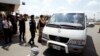 A van drives four refugees from Australia out of Phnom Penh International Airport, in Phnom Penh, Cambodia, Thursday, June 4, 2015.