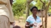 Information teams are chosen from the communities to disseminate information about residual spraying. They go door-to-door explaining the process and when it will take place, Mozambique, Nov. 13, 2014. (Gillian Parker/VOA)