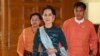FILE - National League for Democracy party (NLD) leader Aung San Suu Kyi, center, arrives at Myanmar's parliament in Naypyitaw, Myanmar, March 15, 2016. 
