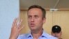 FILE - Russian opposition leader Alexei Navalny, who is charged with participation in an unauthorized protest rally, attends a court hearing in Moscow, July 1, 2019. 