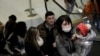 Security personnel wear face masks as they stand at the gate of the Shanghai Disney Resort, which announced that it will be closed indefinitely from Saturday, in Shanghai, Jan. 25, 2020.