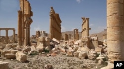 FILE - This photo released March 28, 2016, by the Syrian official news agency SANA shows some damage inflicted by Islamic State attacks at the ancient ruins of Palmyra, central Syria. 